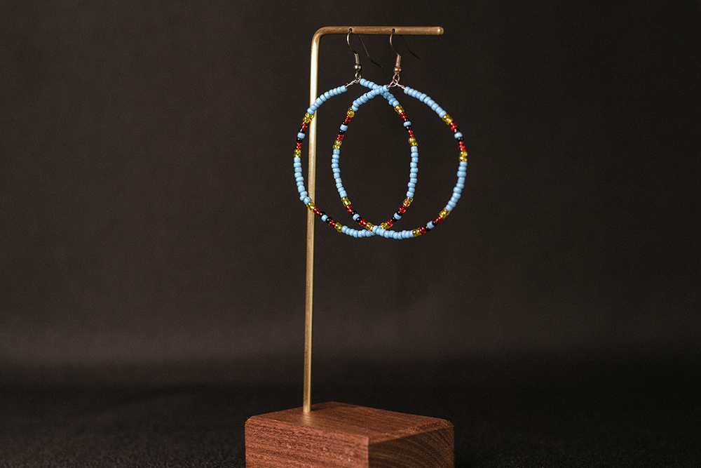 Simple hoops hand-beaded with turquoise yellow, black, and red beads.