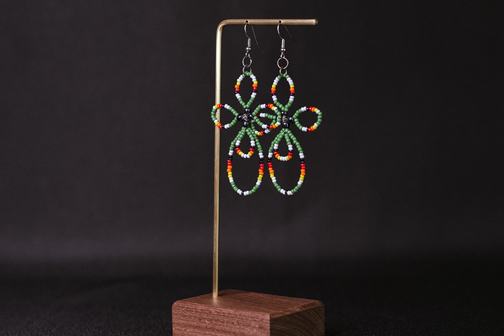 Hand-made long green, orange, red, white, and black cross earrings.