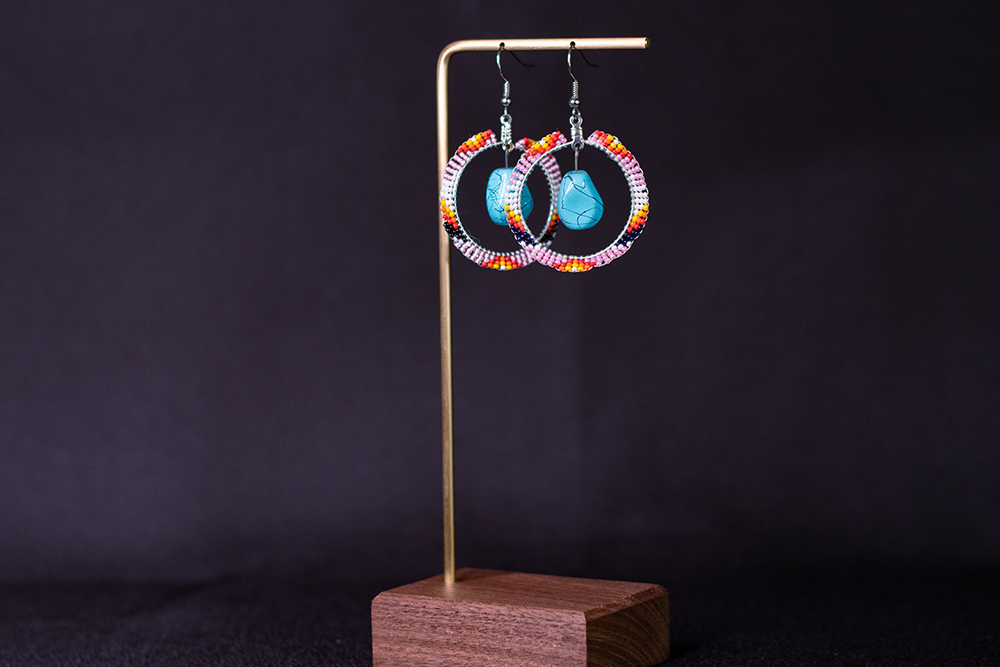 Hand-made turquoise hoops, with beaded outer hoop. Uses beads of pink, red, black, and white.