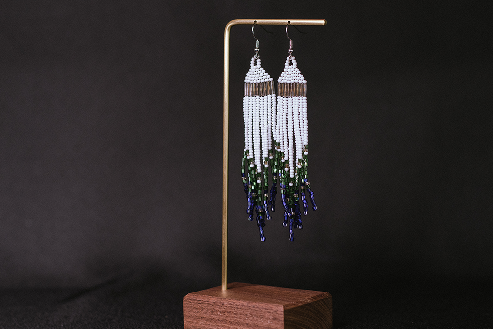 Hand-made earrings with white, silver, green, and blue beads